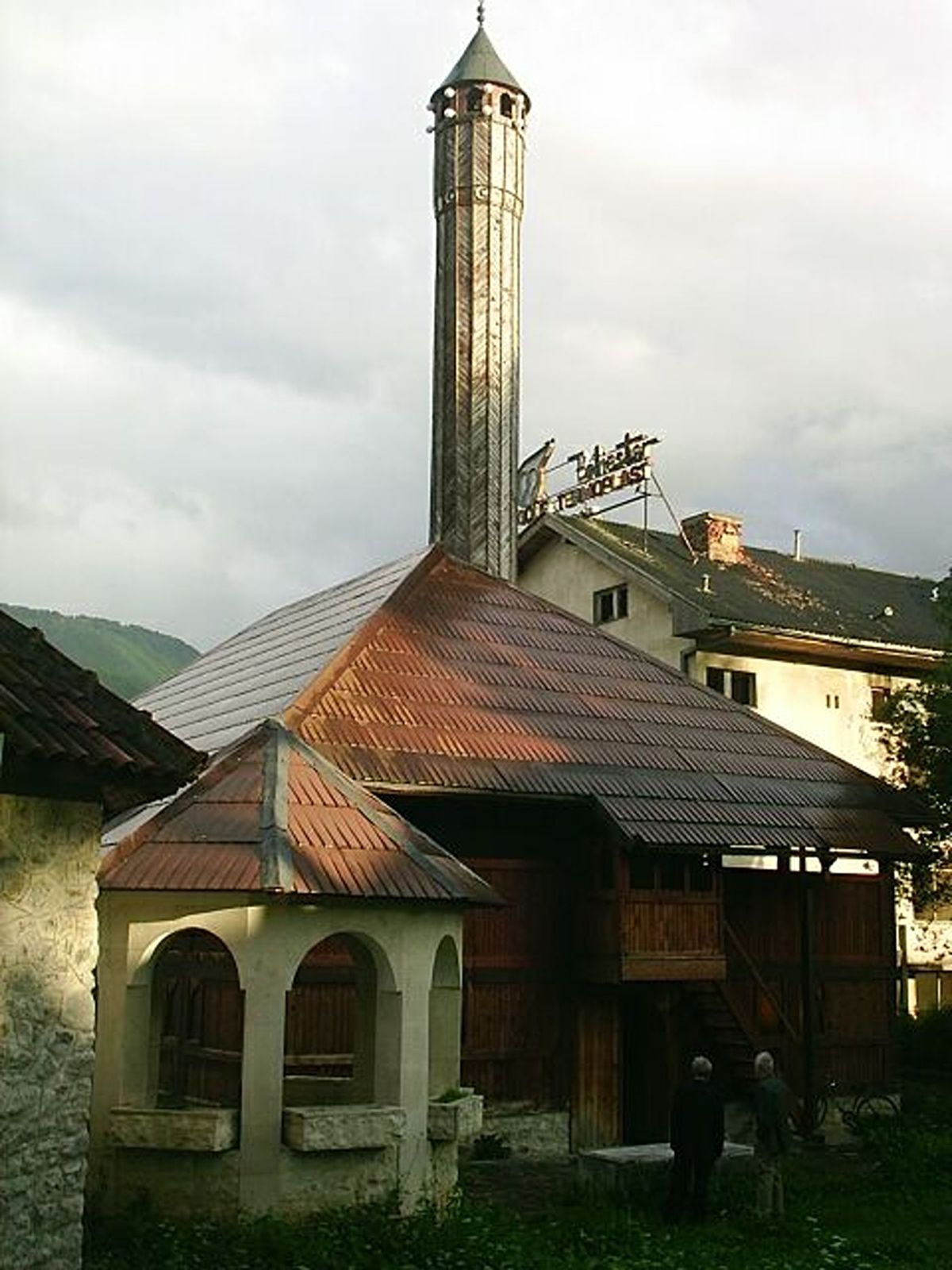 The historic Vizier's Mosque (Vezirova Džamija) in Gusinje, Montenegro, a unique wooden mosque with a large shingled roof and an intricately carved wooden minaret