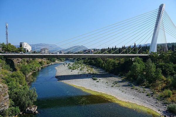 The elegant Millennium Bridge, a symbol of modern Podgorica, gracefully spans the Morača River, connecting the city's past and future.