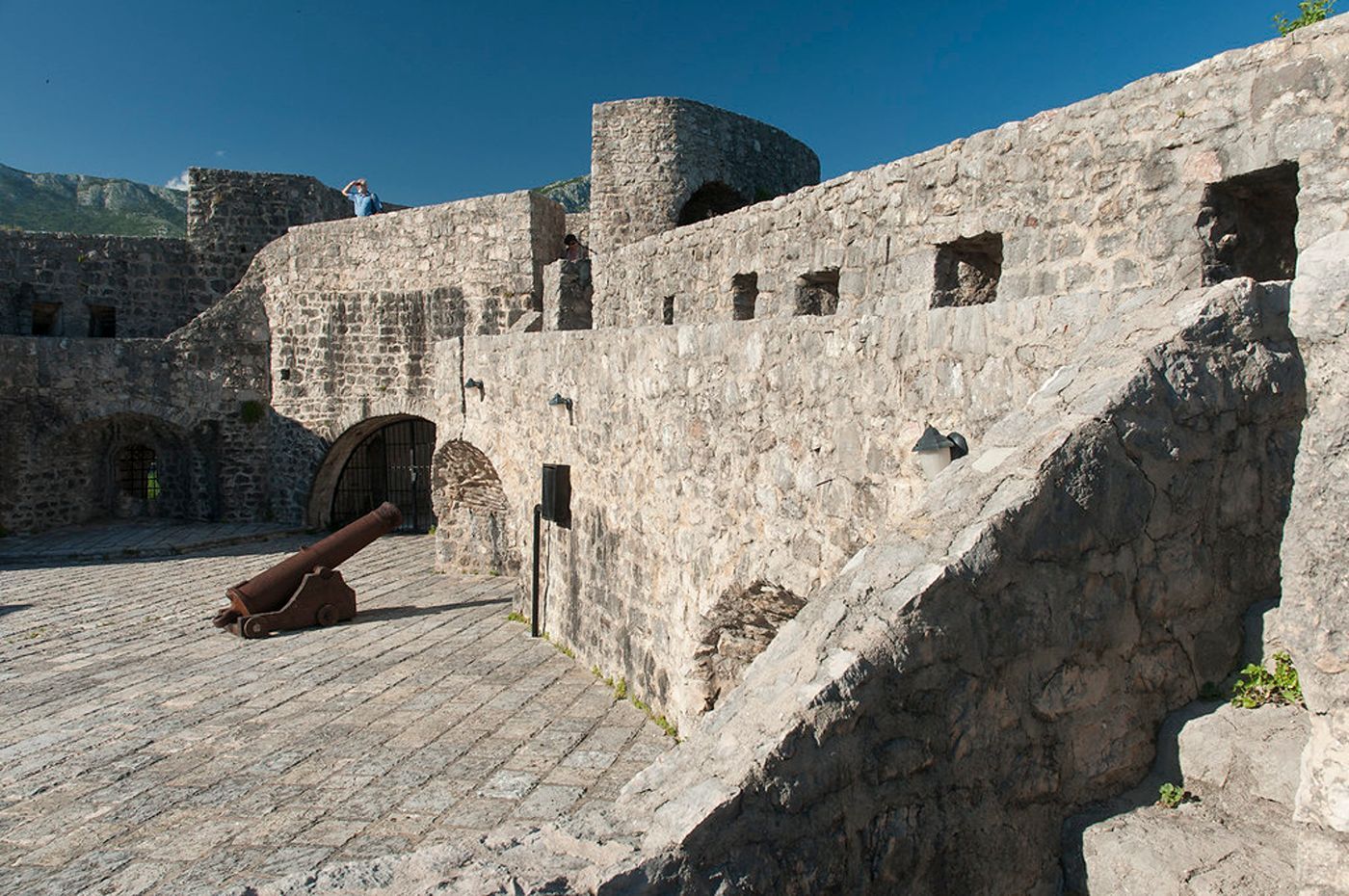 The historic stone walls and a cannon on the grounds of the 16th-century Kanli Kula Fortress.