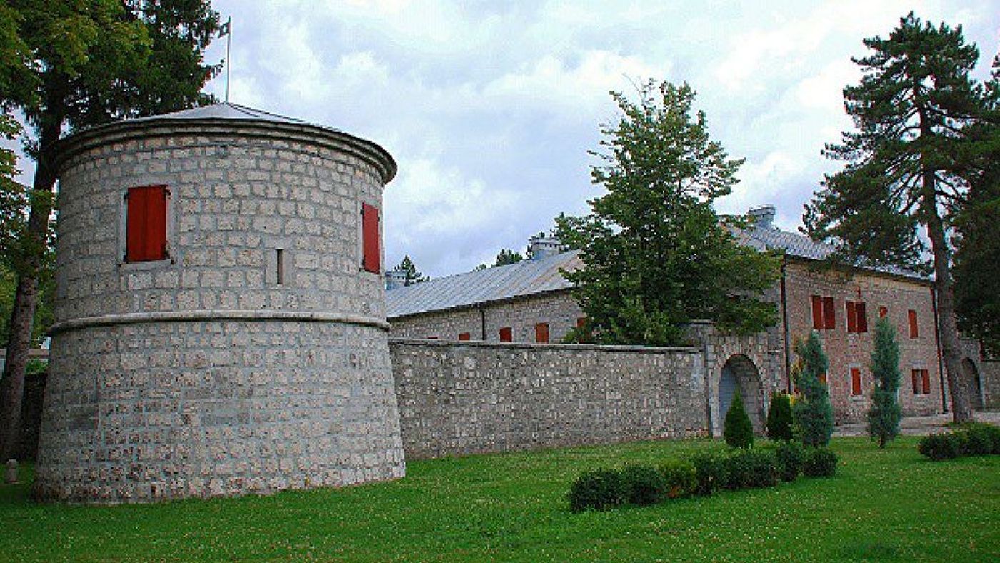 A view of a corner tower and the main building of Biljarda Hall, resembling a medieval fortress.