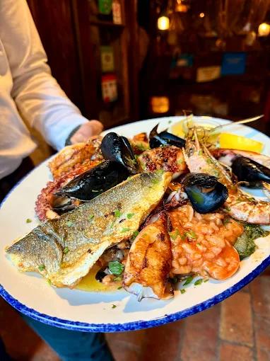 A generous platter of mixed grilled seafood, including fish, mussels, and octopus, served at Konoba Scala Santa.