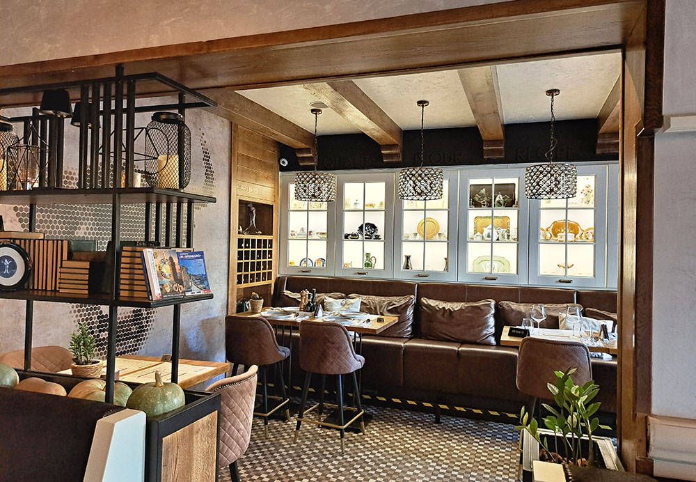 The stylish and cozy interior of the Steak House in Podgorica, with a comfortable brown leather booth and elegant decor.