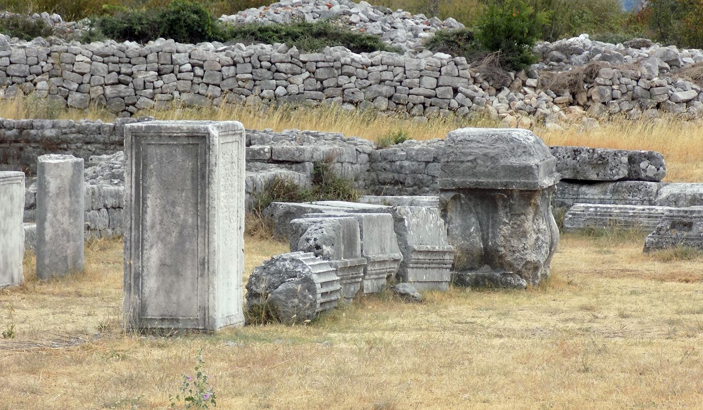 A close-up of intricately carved Roman sarcophagi and stone blocks at the Duklja archaeological site.