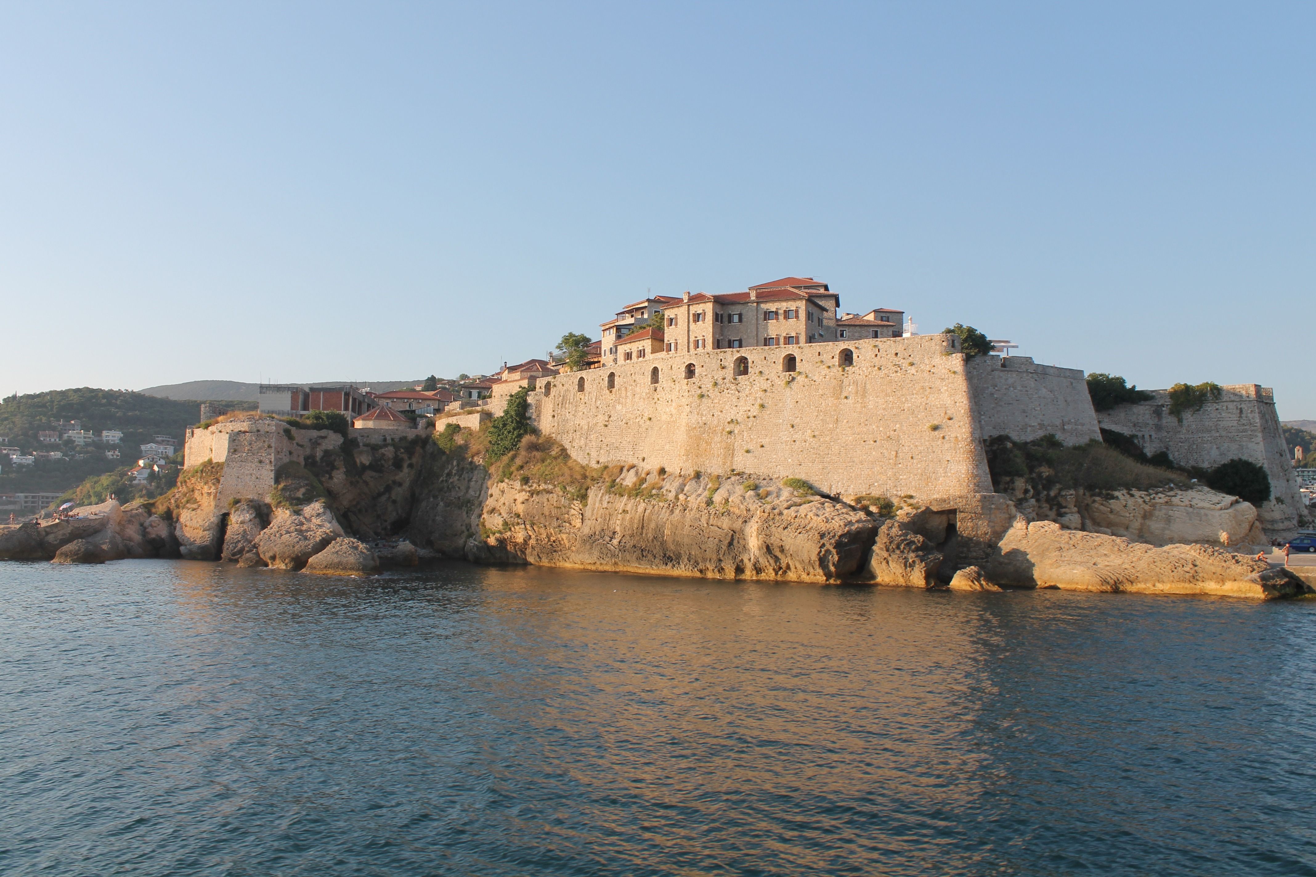 The impressive stone fortress walls of Stari Grad Ulcinj as seen from the sea.