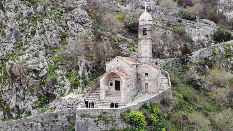 The historic stone Church of Our Lady of Remedy nestled into the mountainside along the Kotor city walls trail.