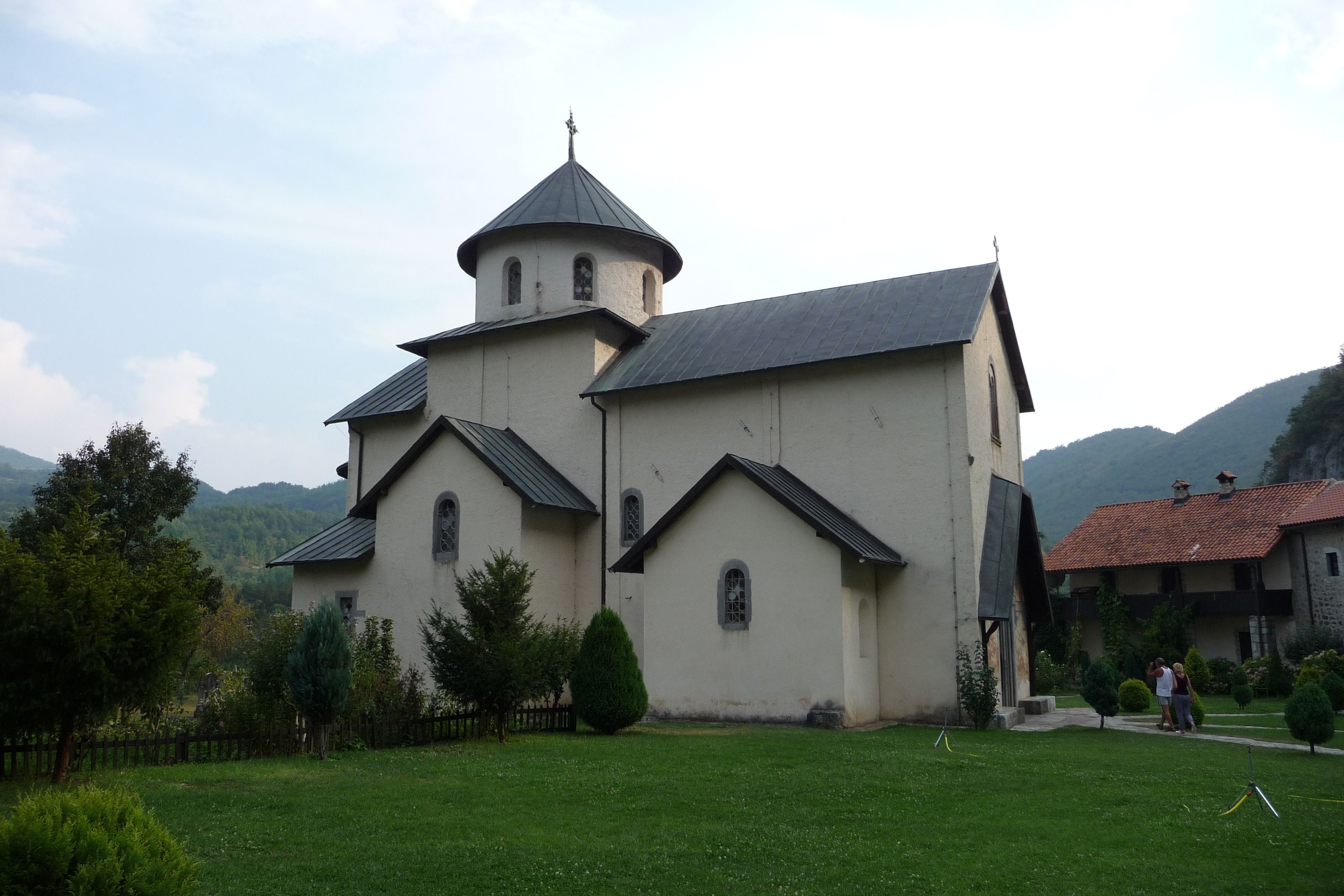 The historic main church of the Morača Monastery in its peaceful, green courtyard in Montenegro.