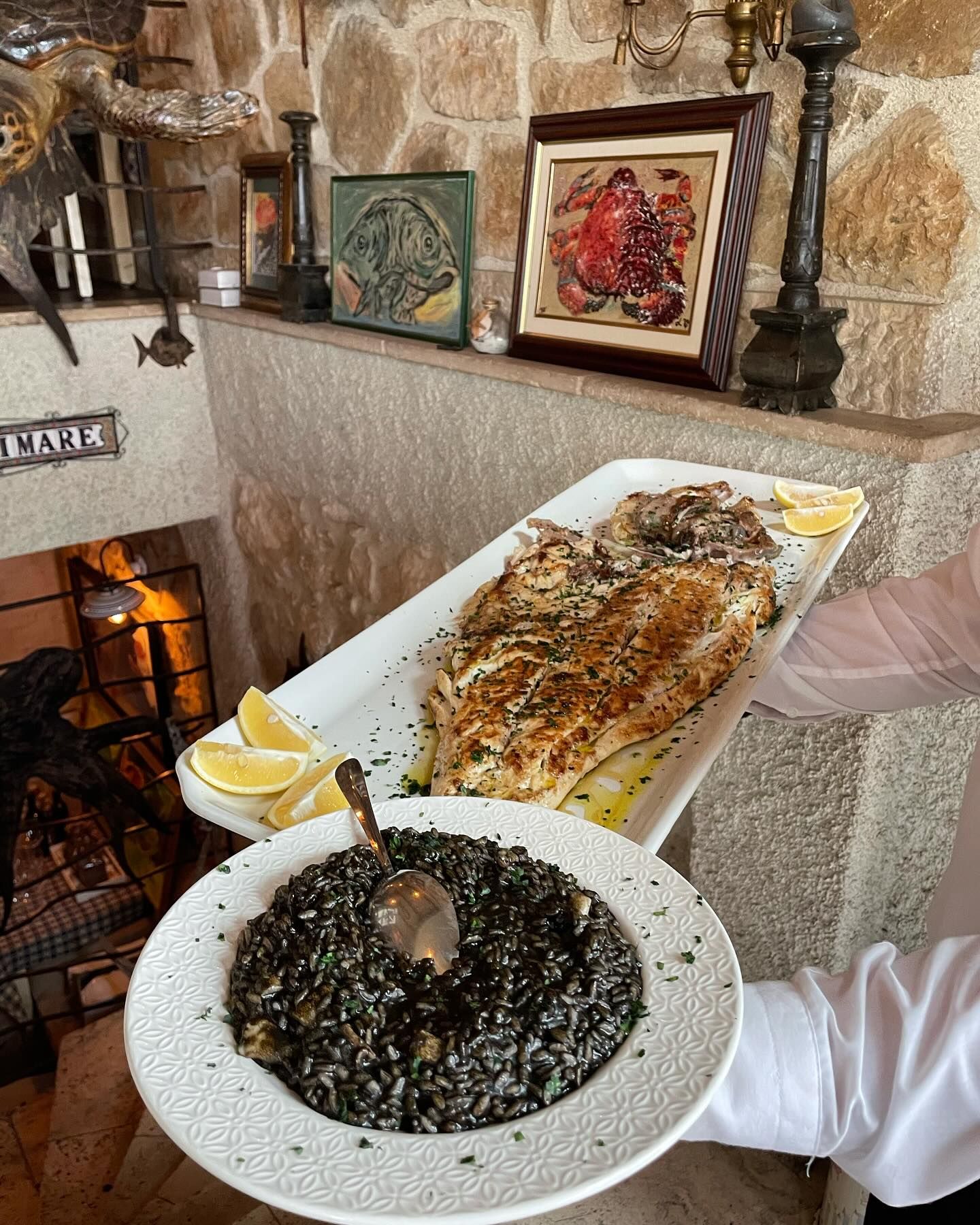 A view of the rustic decor at Lupo di Mare, with a wooden wine rack and intricate latticework.