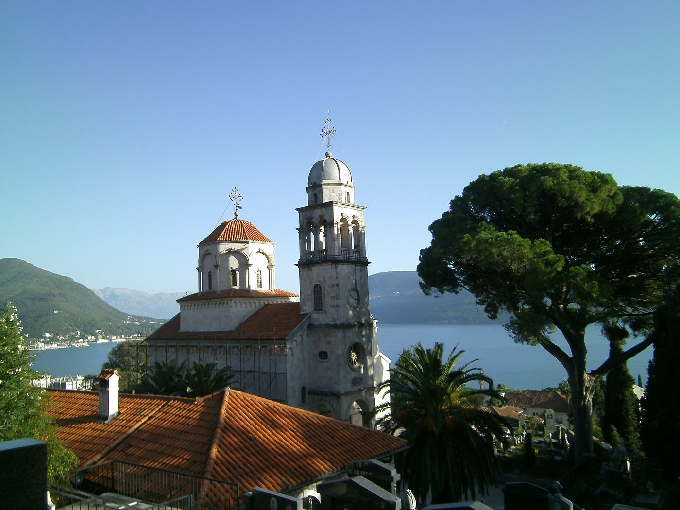 The 18th-century main church of the Savina Monastery, with its stone bell tower and red-tiled roof.