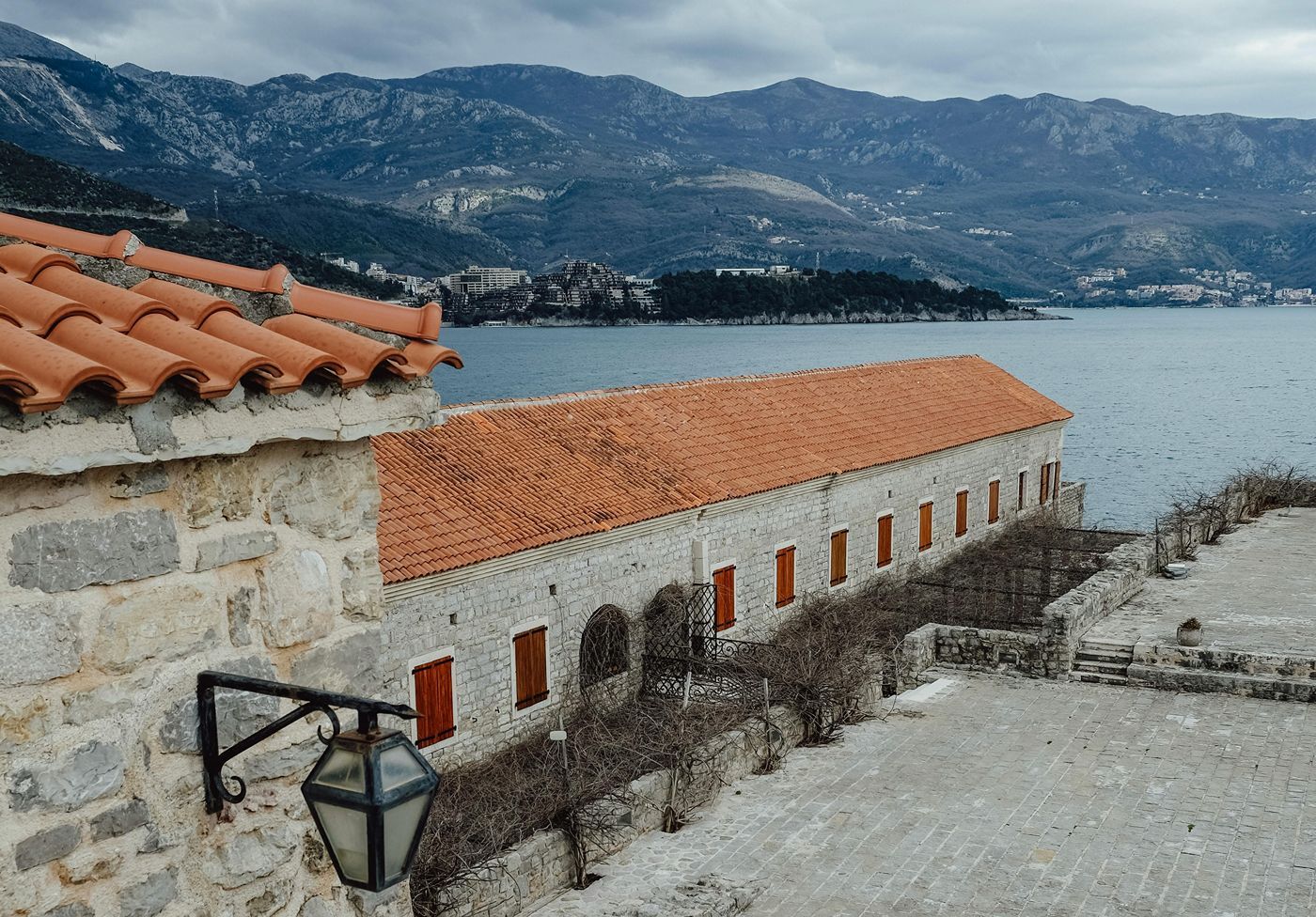 A view from the walls of the Citadel in Budva, looking out over the Adriatic Sea and the mountainous coastline.