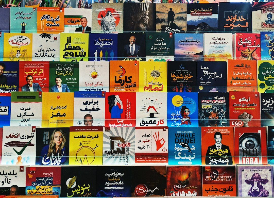 Assorted Persian books neatly arranged on a shelf