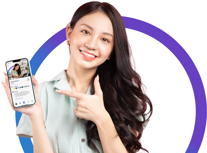 Smiling woman pointing at her phone showing the Cadooga app profile screen