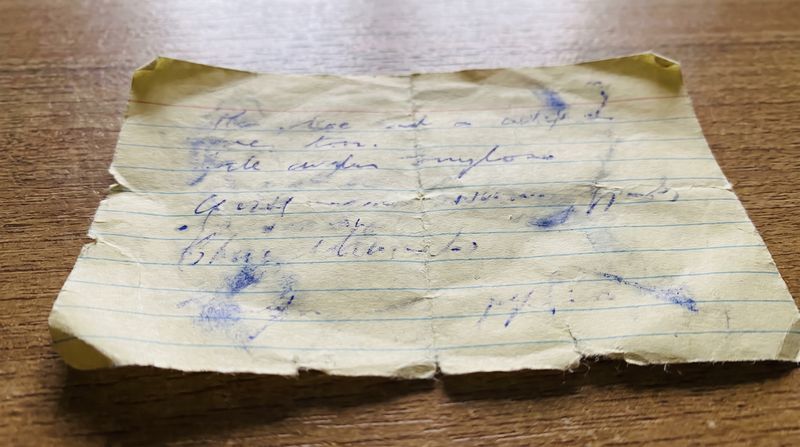 A close view of an old handwritten note on lined paper, ink faded with age