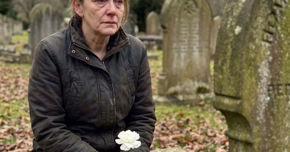 A mother sitting quietly on a stone bench in a peaceful cemetery