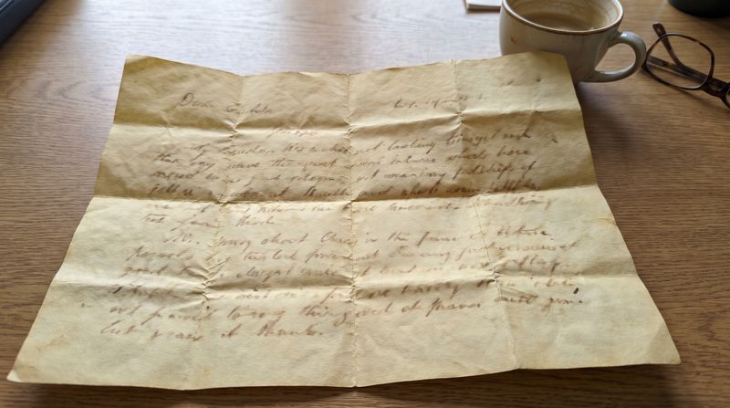 An old handwritten letter on yellowed paper, folded from decades of storage