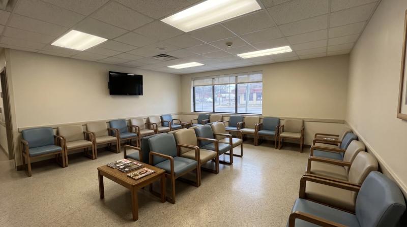An empty hospital waiting room with rows of chairs