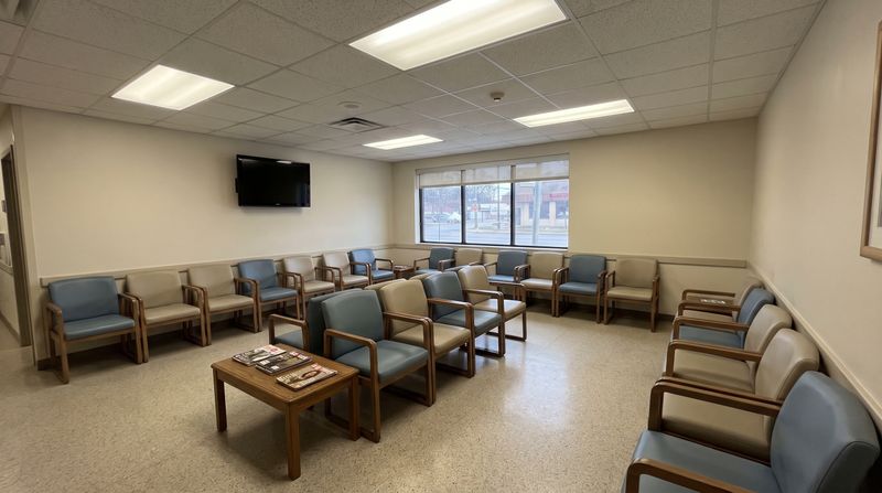 An empty hospital waiting room with rows of chairs