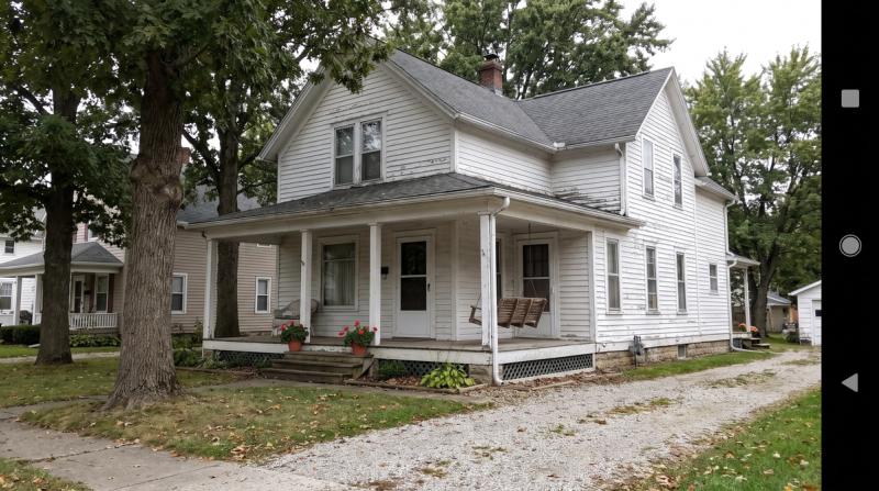 A modest, lovingly built family home with a front porch in warm evening light