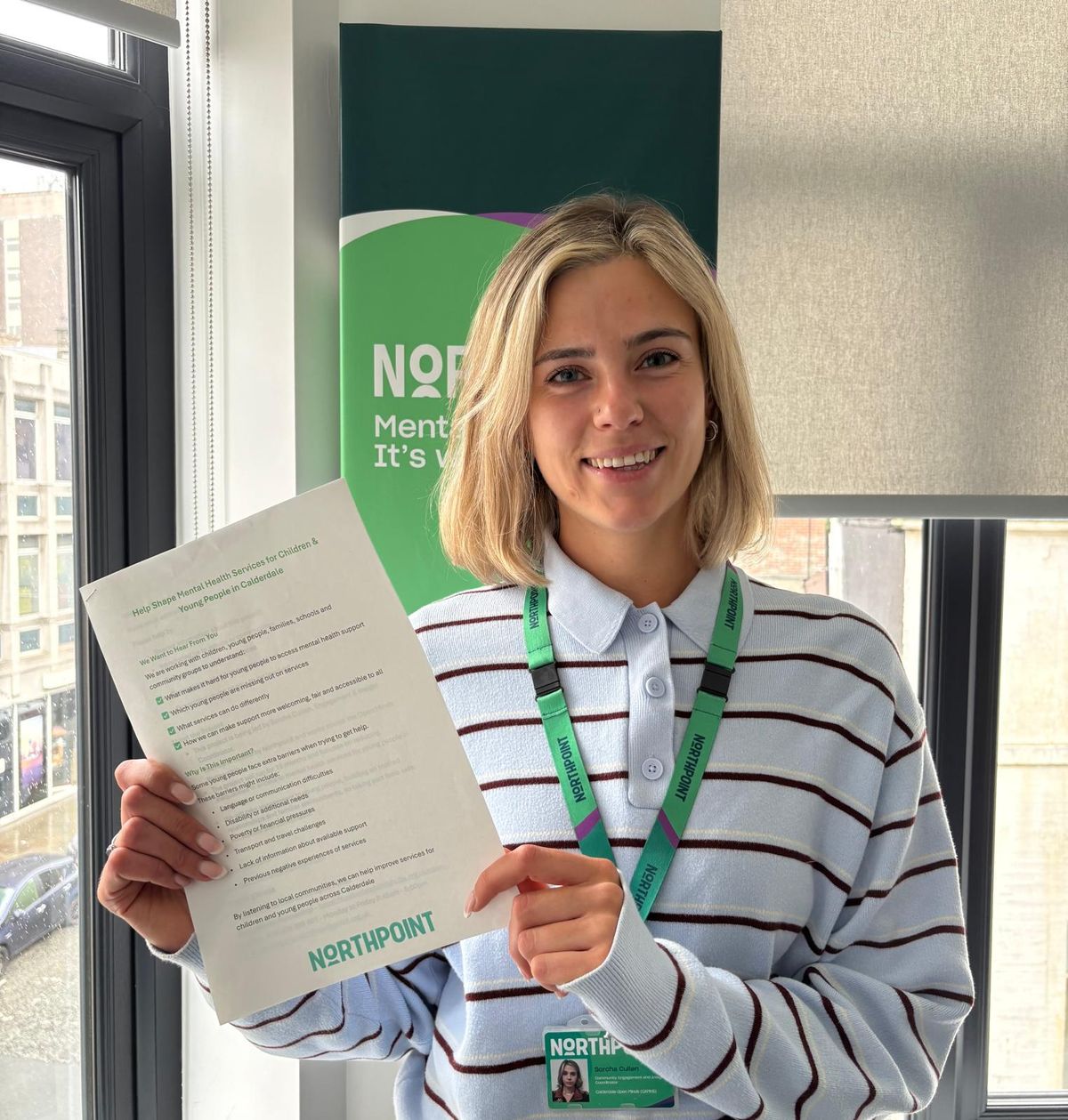 Staff member holding questionaire