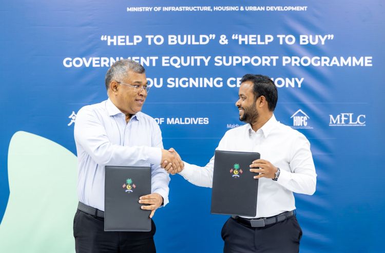 Housing Minister Dr Abdulla Muththalib shaking hands with BML CEO Mohamed Shareef after signing a memorandum of understanding