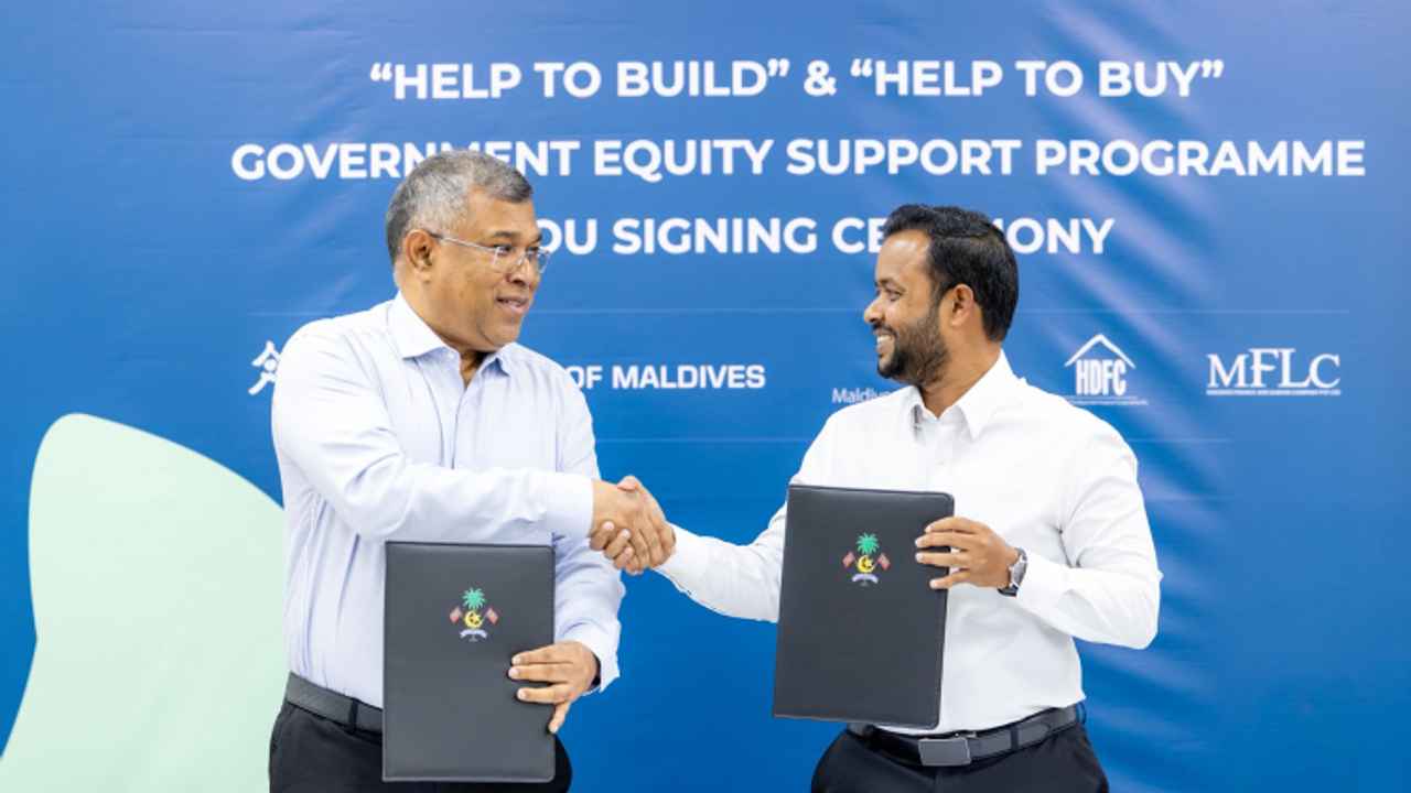 Housing Minister Dr Abdulla Muththalib shaking hands with BML CEO Mohamed Shareef after signing a memorandum of understanding