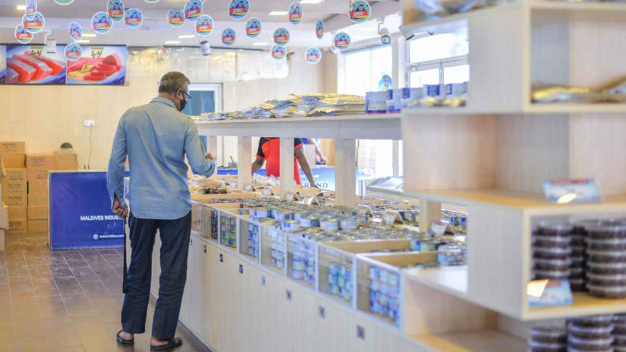 A man in a blue shirt, observing products at a MIFCO outlet