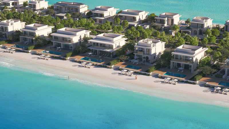 Artist's rendering of white two-storey beachfront villas with private pools and sun loungers, set among trees along a sandy beach and turquoise water.