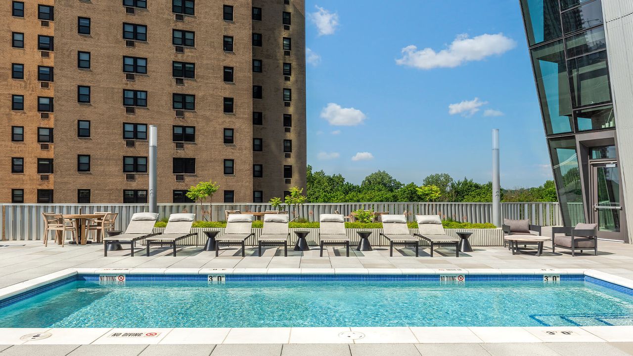 Pool chairs, pool, planting beds, and amenity deck on top of the 100 building in forest park st louis missouri designed by arbolope studio.