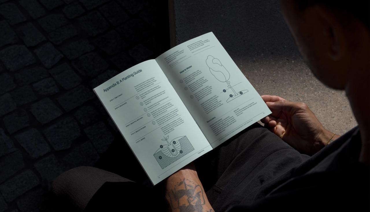 Dramatic photography of a person reading the vacant lots toolkit booklet, vacancy to vibrancy in the st louis missouri community.