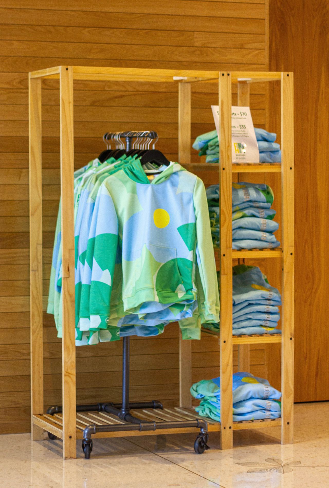 Hoodies on display for sale at the missouri botanical gardens designed by arbolope studio for the society of ethnobiology conference in 2024.