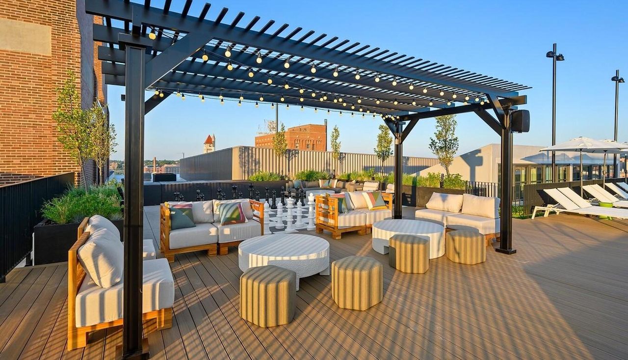 Photo of the top amenity deck and pool with people at the Butler Brothers Building, new landscaping designed by Arbolope Studio of St. Louis Missouri.