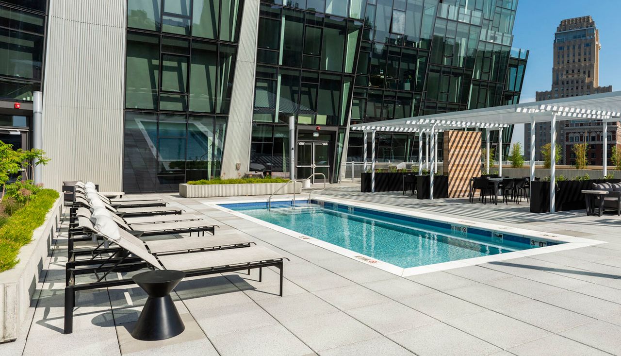 Pool and city view from the top of the 100 building above the park in forest park st louis missouri designed by arbolope studio.