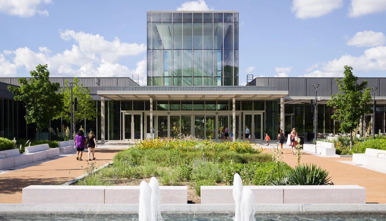 Bright sunny day with people visiting the Interior plaza redesigned by arbolope studio at the Jack c taylor visitor center at the missouri botanical gardens in st louis.