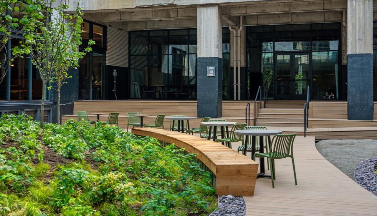 Photo of the top amenity deck and pool with people at the Butler Brothers Building, new landscaping designed by Arbolope Studio of St. Louis Missouri.
