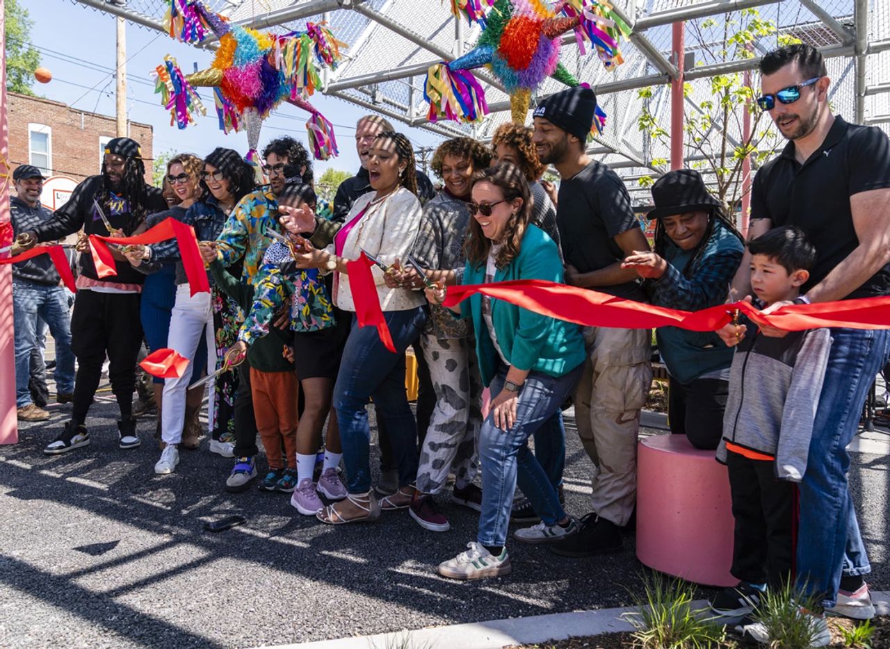 Via STLPR - Community leaders perform a ribbon cutting during the opening of Love Bank Park on Sunday, April 21, 2024, in Gravois Park. The Park, a former vacant lot, was founded in 2015 by members of the Cherokee Street community.