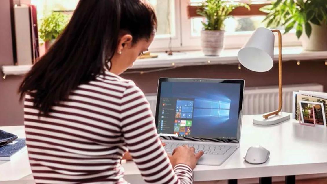 Person at a Surface laptop with Microsoft 365 open