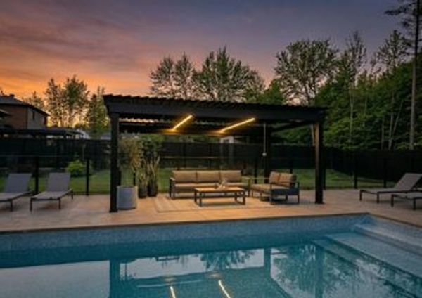 Black aluminum pergola at sunset over a pool