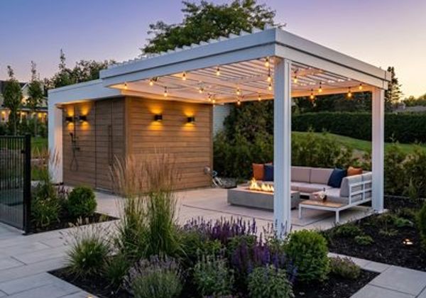 White bioclimatic pergola at dusk with string lights and lounge seating