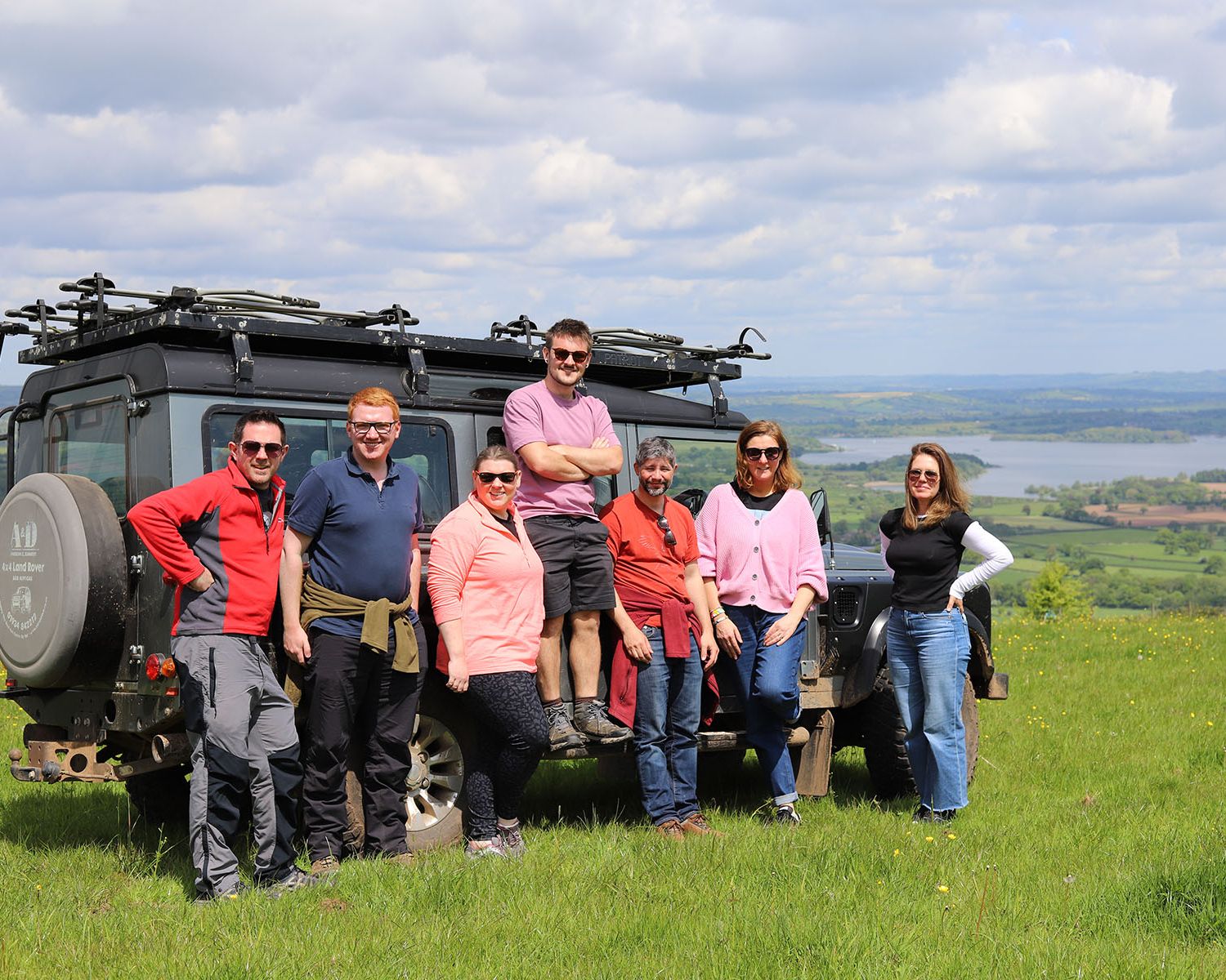 Photo of rural solutions team in front of land rover with countryside in distance