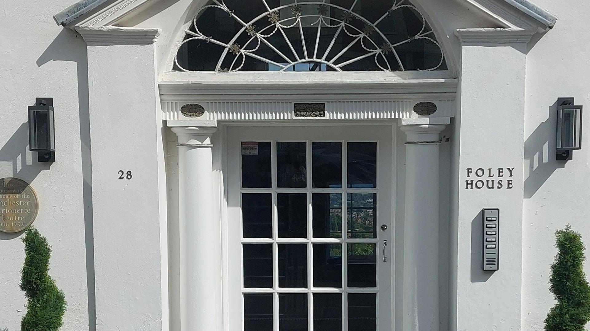 Photograph of the front door of a white Georgian villa