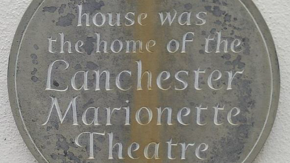 Photograph of a plaque saying; 'This house was the home of the Lanchester Marionette Theatre 1936-1952'