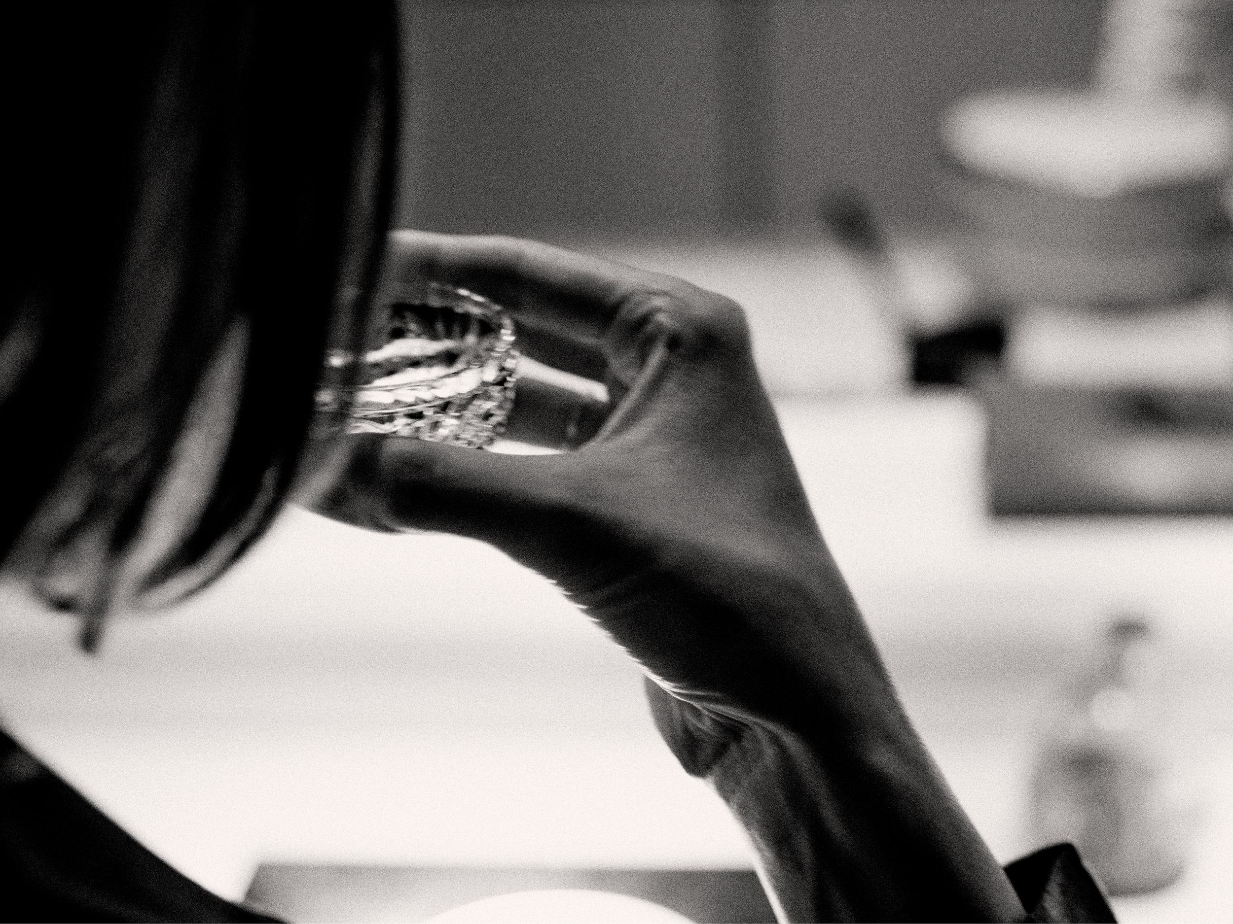 A guest enjoying a glass of sake at Nama, Aman New York. Photographed by Chris Colls.