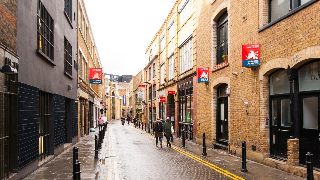 London street with Stirling Ackroyd for sale boards