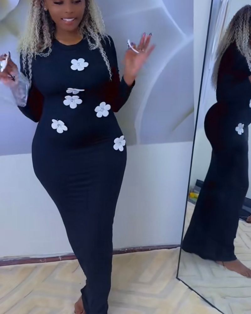 Black bodycon dress with white attached flowers