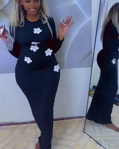 Black bodycon dress with white attached flowers