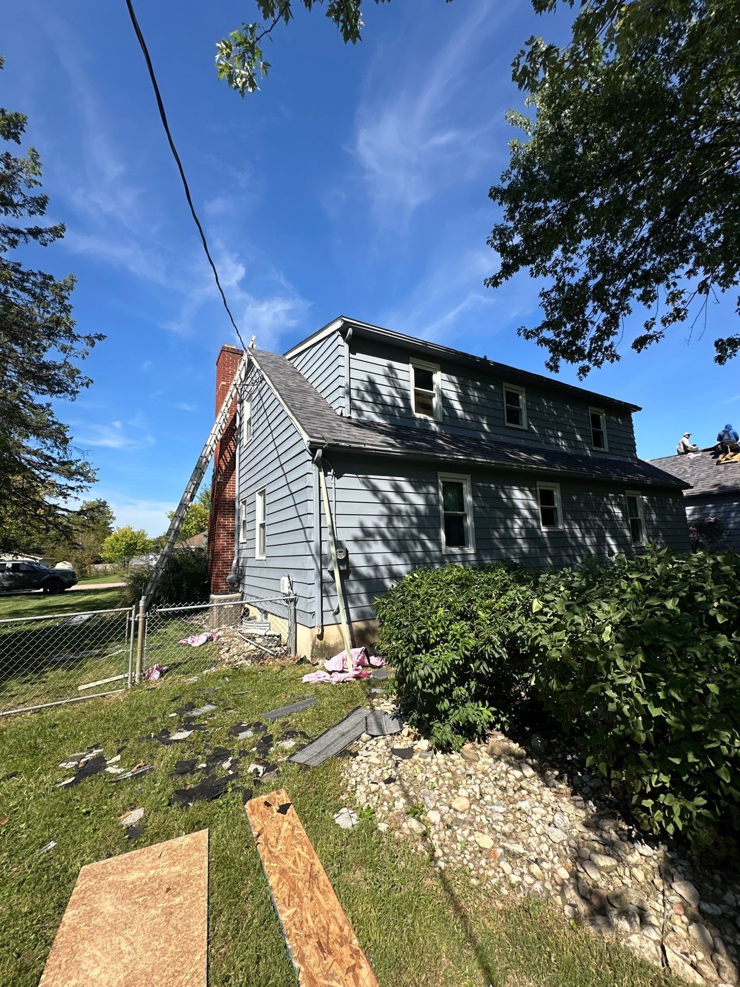 The side yard after tear-off, with sheathing panels on the ground, Beavercreek, Ohio.