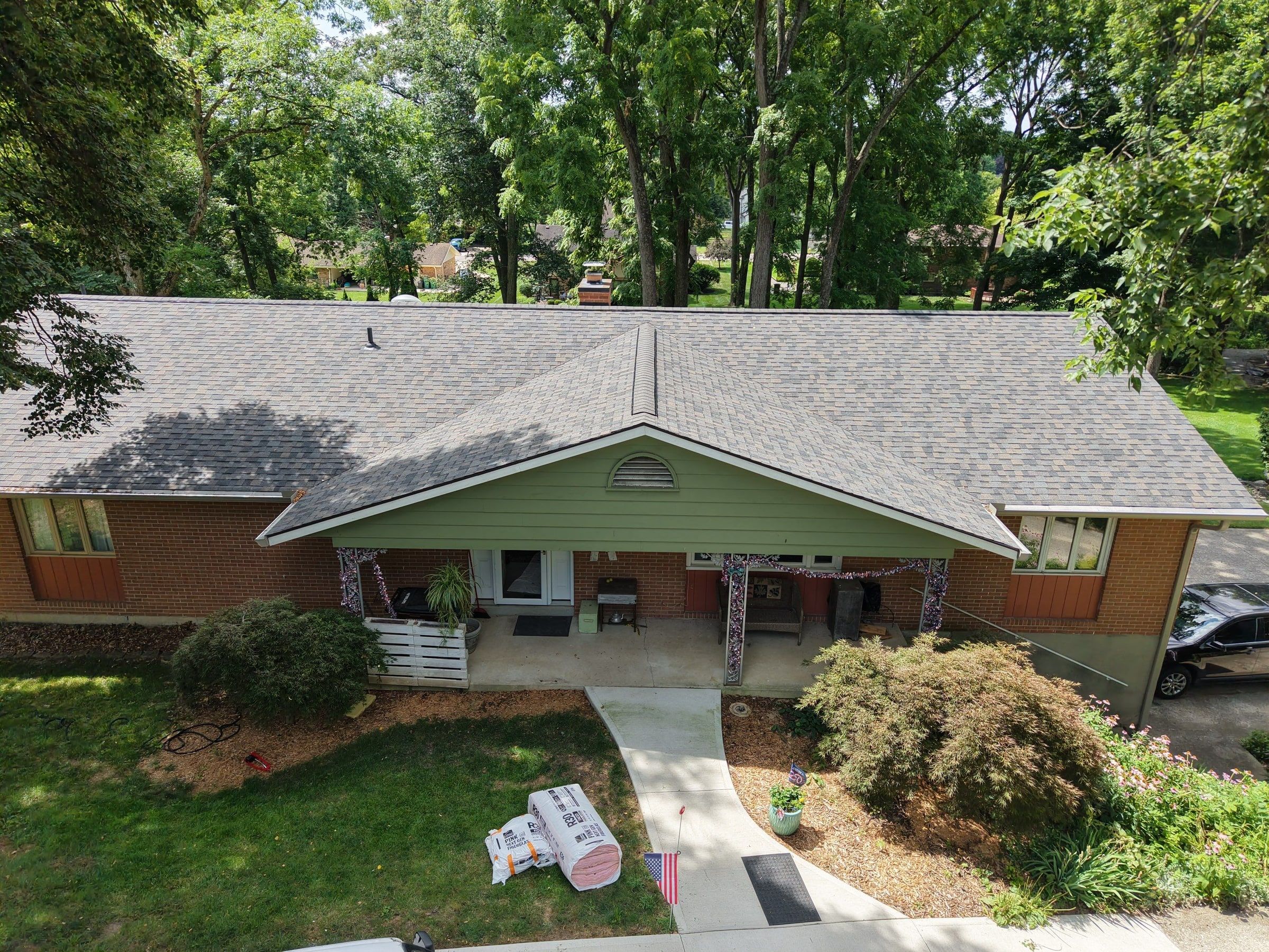 Brick ranch and green gabled porch entry