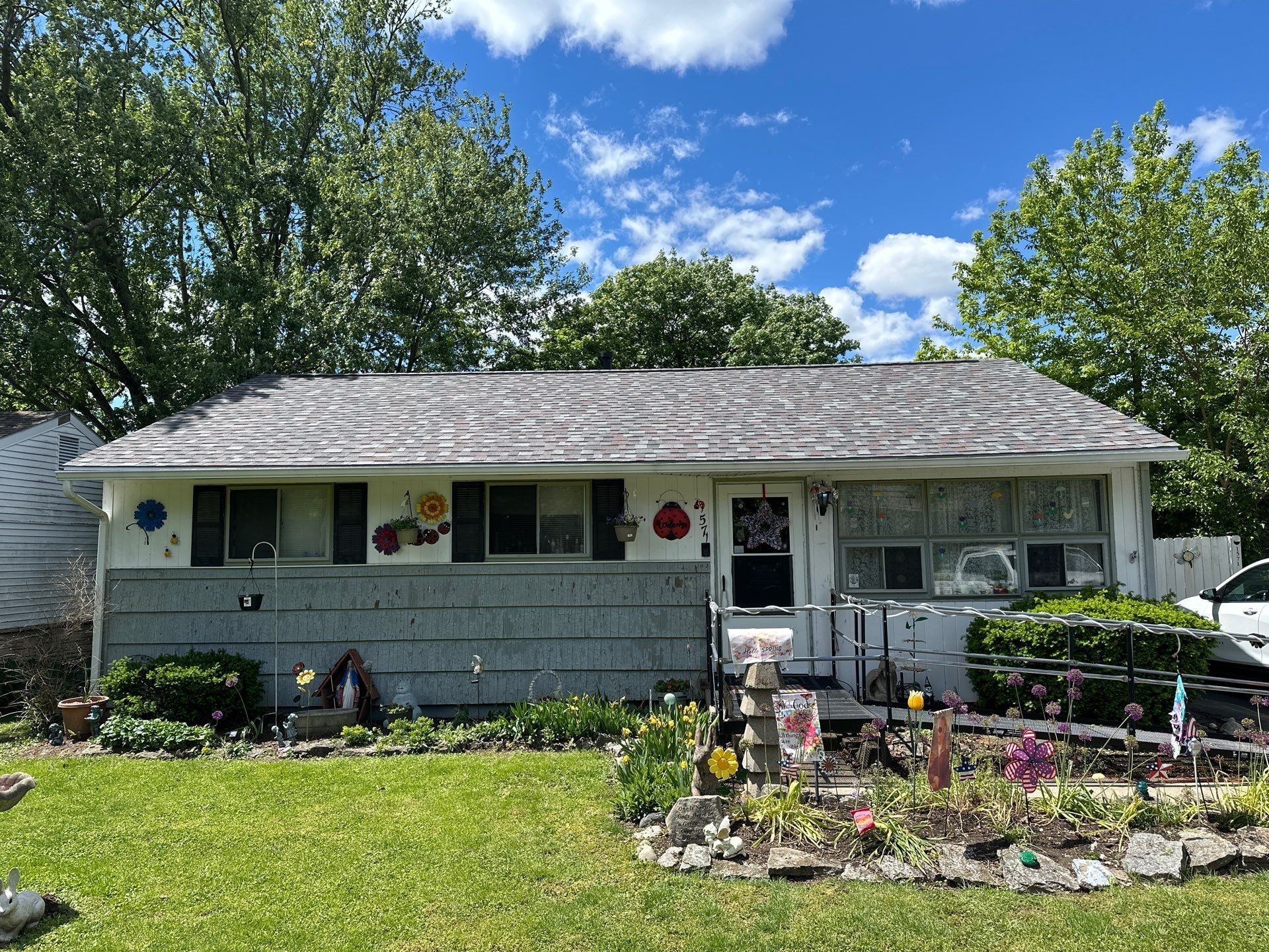 White ranch, black shutters and garden ornaments