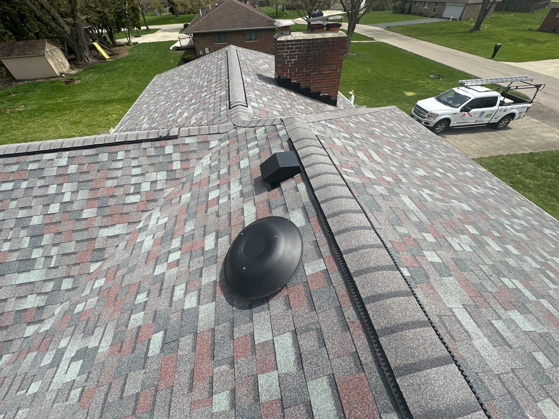 Round roof vent and square exhaust vent beside the new ridge vent, Beavercreek, Ohio.