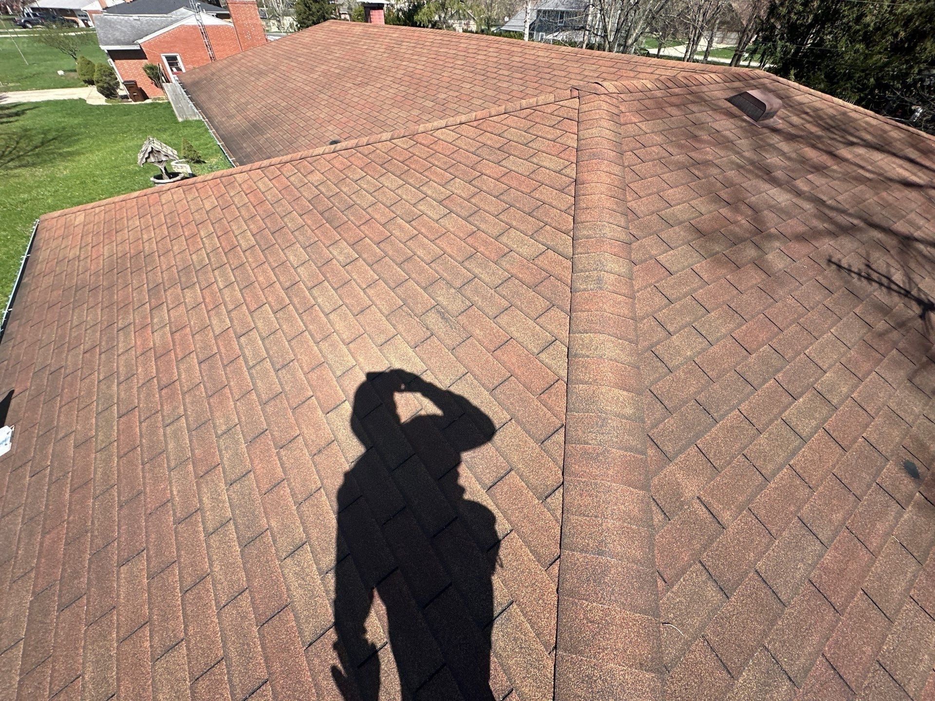 Hip roof slope from above showing the worn reddish brown shingles, Beavercreek, Ohio.