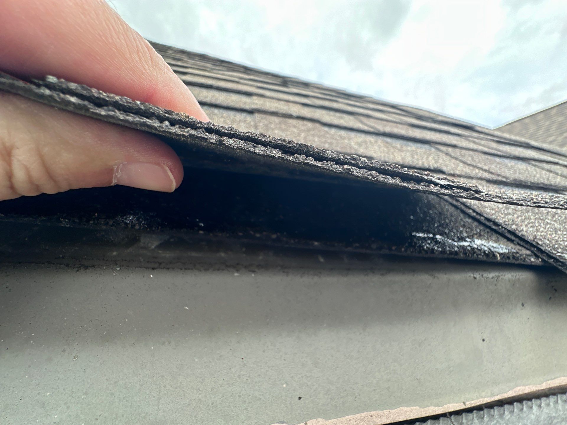 Roof edge metal held clear by hand